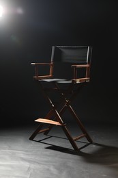 Photo of One empty director's chair on black background