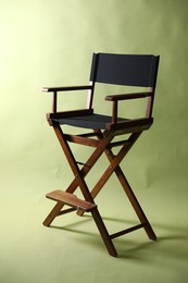 Photo of One empty director's chair on pale olive background