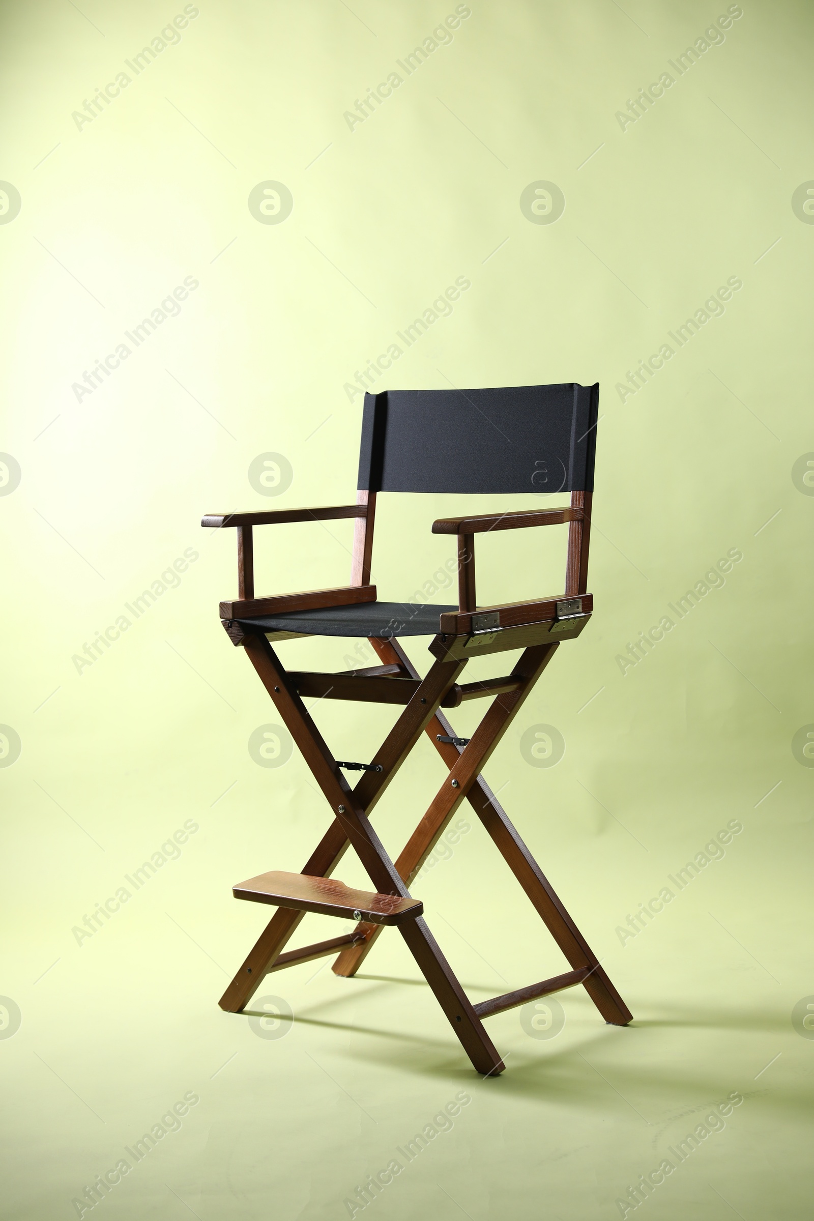 Photo of One empty director's chair on pale olive background