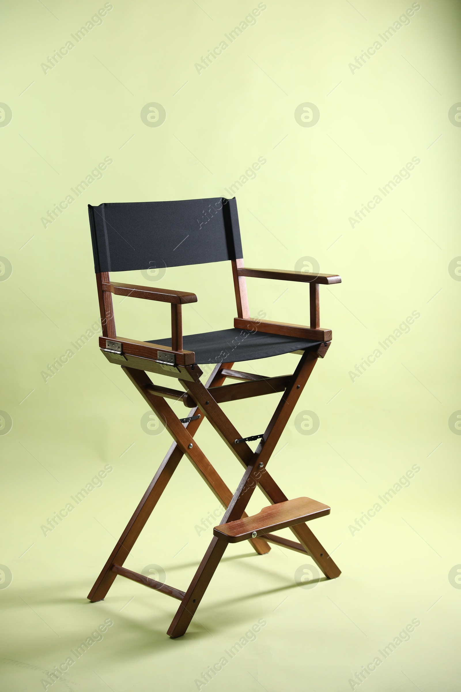 Photo of One empty director's chair on pale olive background