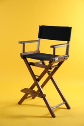 Photo of One empty director's chair on yellow background