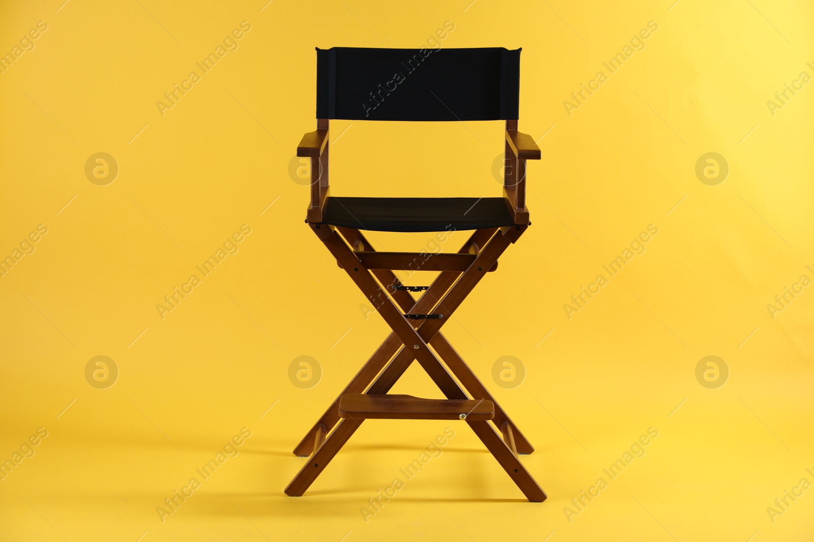 Photo of One empty director's chair on yellow background