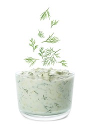 Image of Fresh green dill falling into bowl of sauce on white background