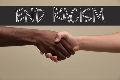 End racism. Men of different race shaking hands on dark beige background, closeup