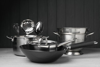 Photo of Dishware and cooking utensils on grey wooden table