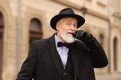 Photo of Elegant bearded senior man on city street