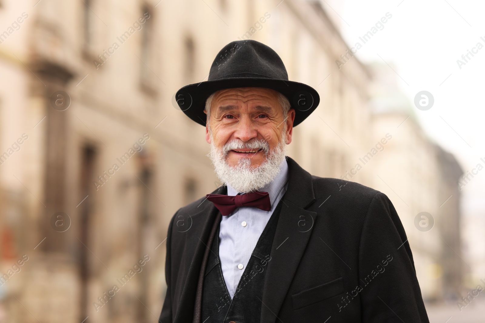 Photo of Elegant bearded senior man on city street