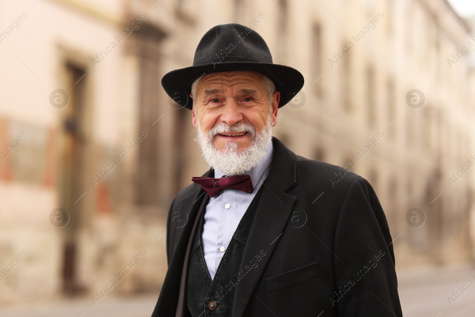 Photo of Elegant bearded senior man on city street