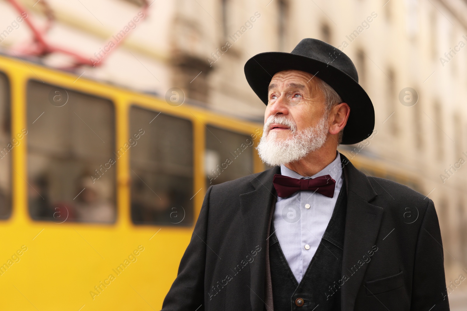 Photo of Elegant bearded senior man on city street