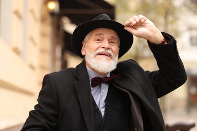 Photo of Elegant bearded senior man on city street