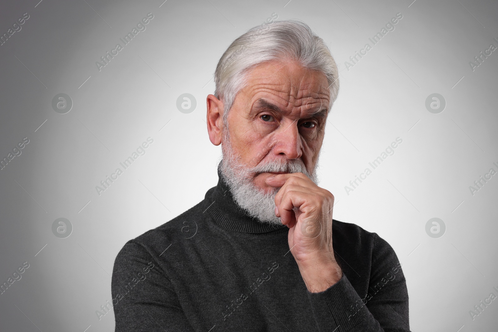 Photo of Portrait of confident senior man with silver beard on light grey background