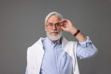 Photo of Portrait of stylish bearded man on grey background