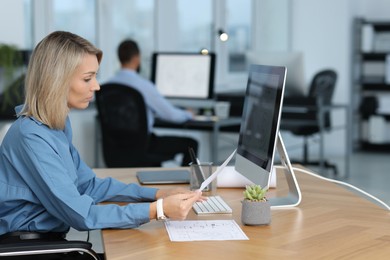 Photo of Technician making digital engineering drawing on computer at desk in office