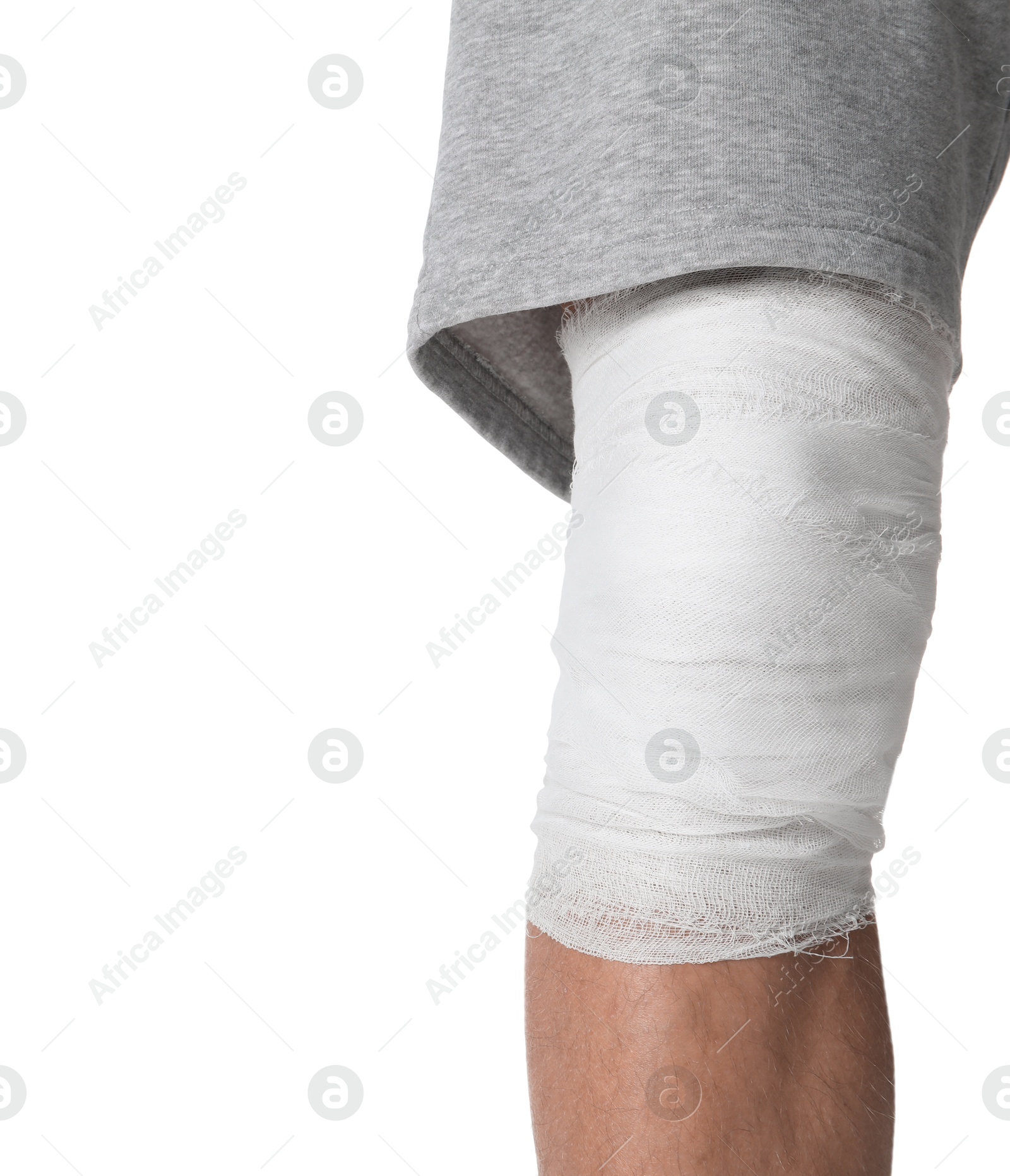 Photo of Man with medical bandage on his knee against white background, closeup