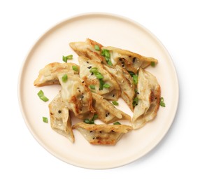 Photo of Tasty fried gyoza dumplings with green onion isolated on white, top view