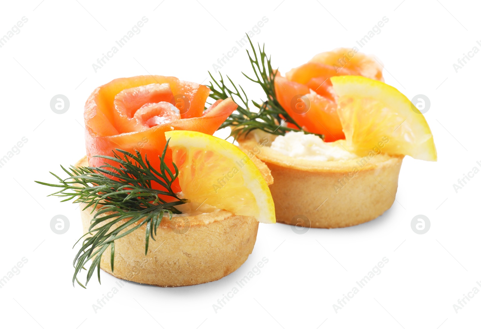 Photo of Tasty tartlets with salmon, lemon and dill isolated on white