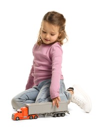 Photo of Little girl playing with toy car on white background