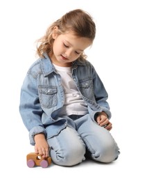 Photo of Little girl playing with toy car on white background