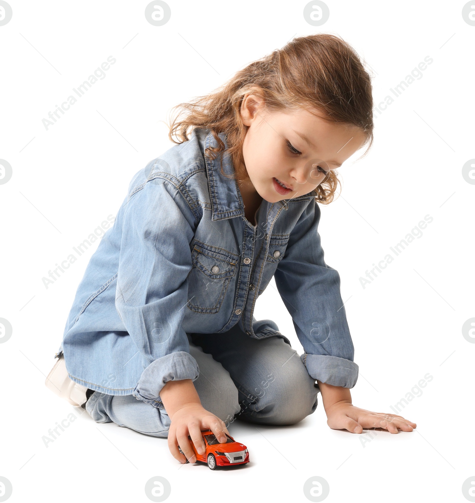 Photo of Little girl playing with toy car on white background