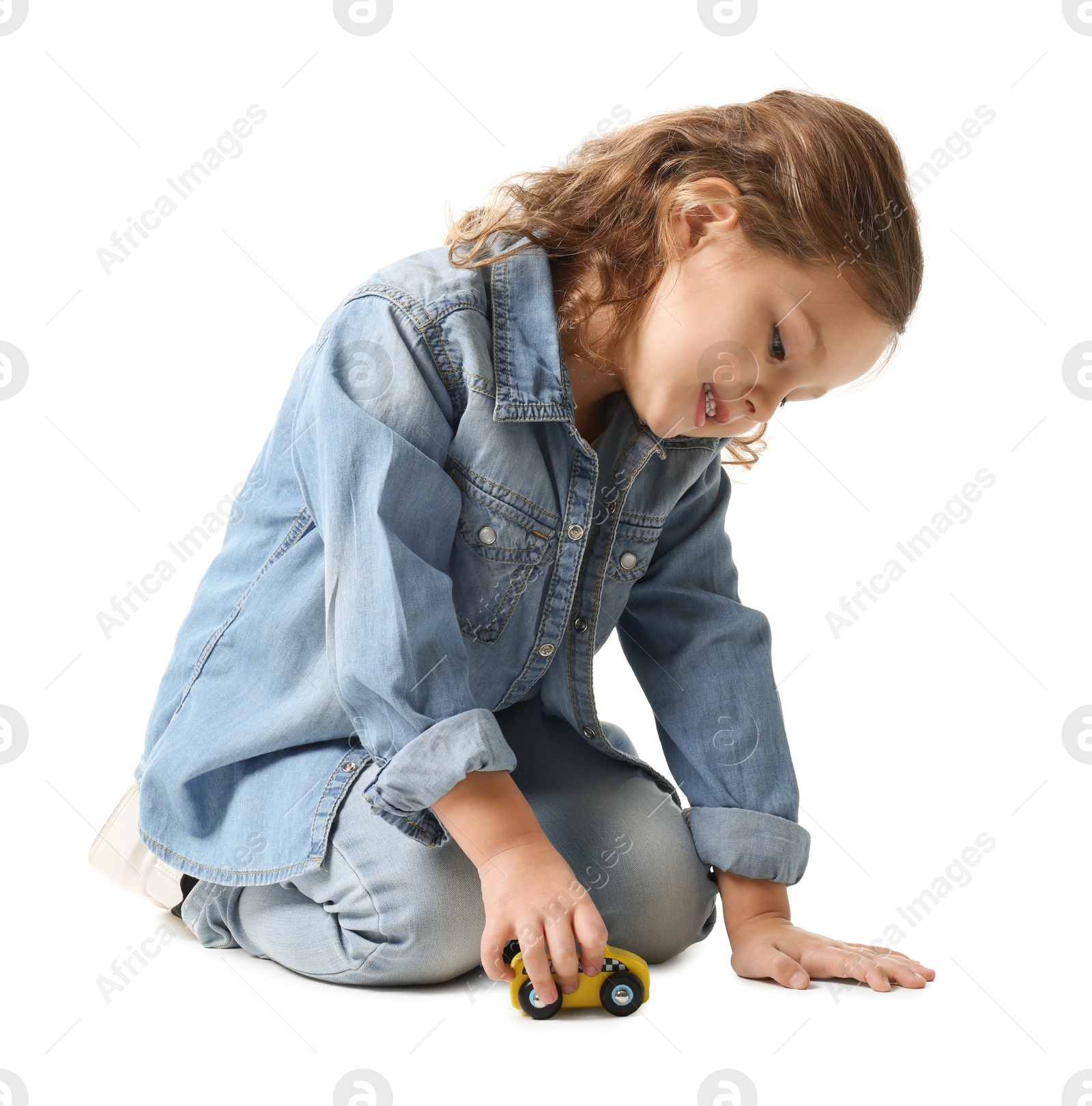 Photo of Little girl playing with toy car on white background