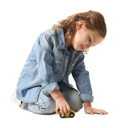 Photo of Little girl playing with toy car on white background