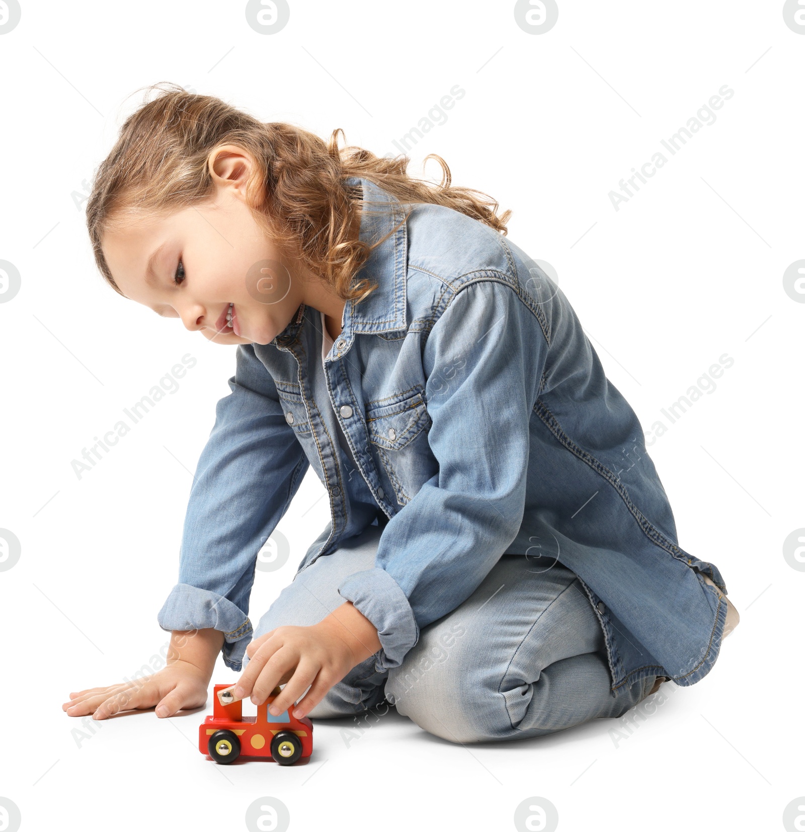 Photo of Little girl playing with toy car on white background