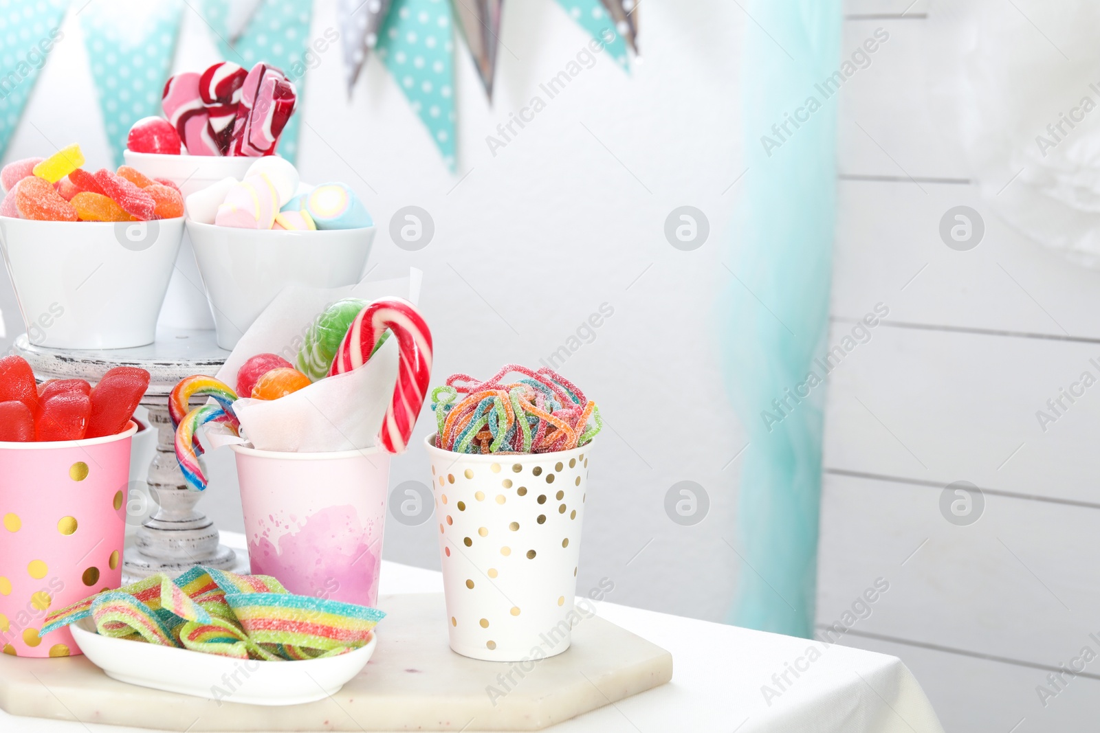 Photo of Candy bar. Different yummy sweets on white table indoors. Space for text