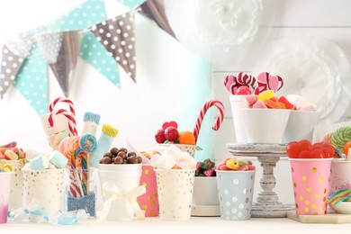 Photo of Candy bar. Different yummy sweets on white table indoors