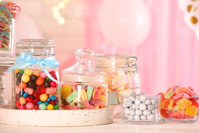 Photo of Candy bar. Many different sweets on white wooden table in festive decorated room