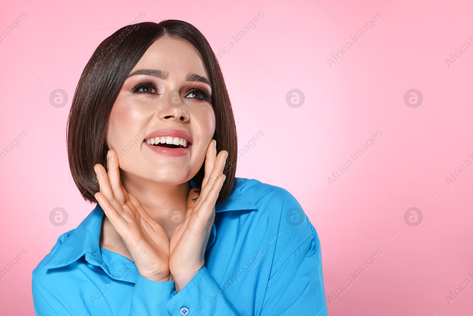 Photo of Portrait of beautiful young happy woman with gorgeous straight hair on pink background, space for text