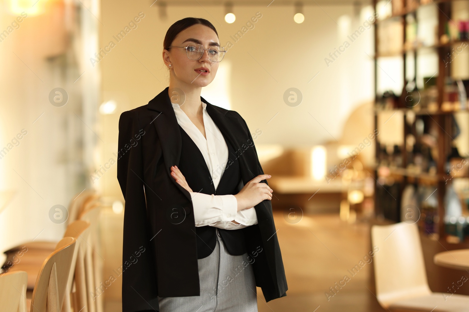 Photo of Beautiful woman in stylish formal suit indoors. Space for text