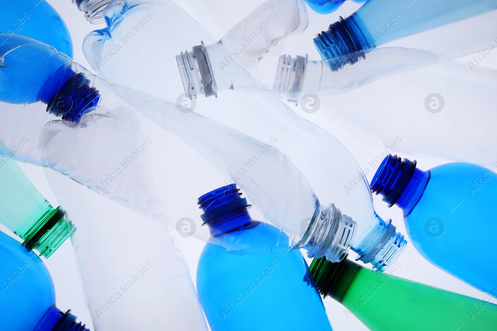 Photo of Empty plastic bottles on white background, top view