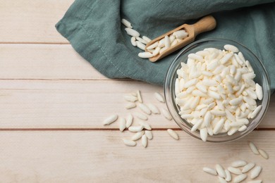 Photo of Puffed rice in bowl and scoop on white wooden table, flat lay. Space for text