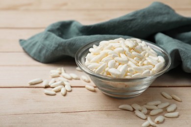 Photo of Puffed rice in bowl on white wooden table, closeup