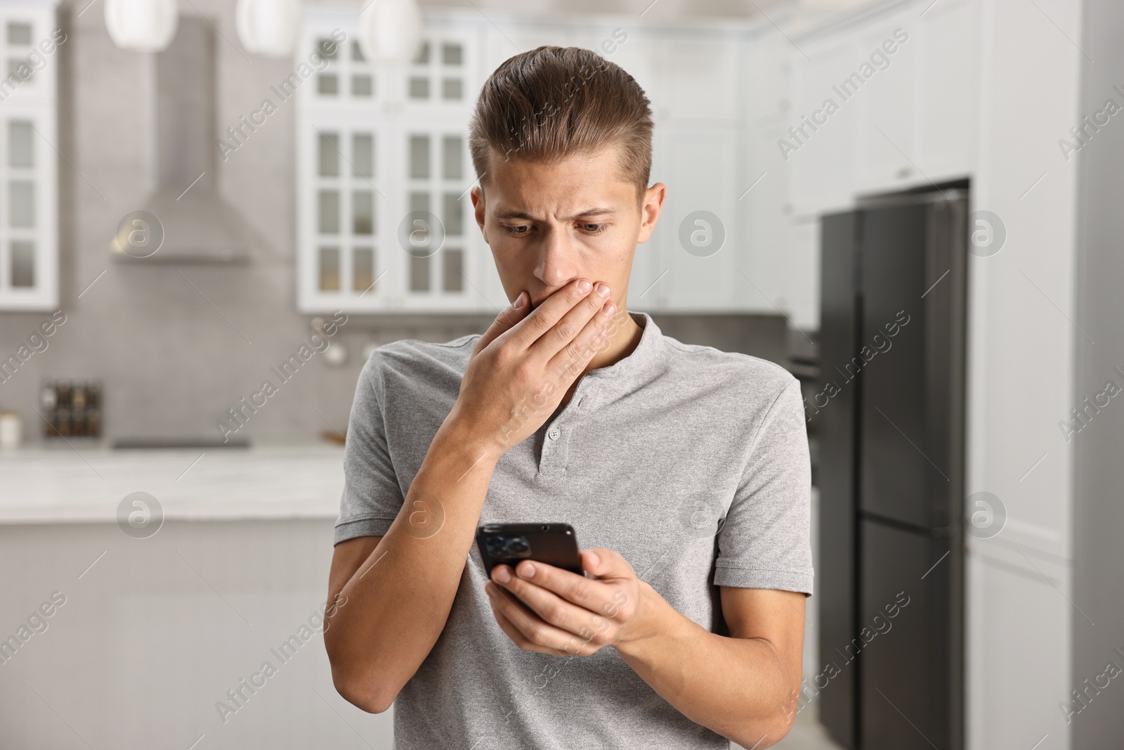 Photo of Worried man going to call hotline for mental health help in kitchen