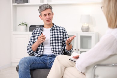 Photo of Professional psychologist working with patient in office, closeup