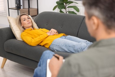 Photo of Professional psychologist working with patient in office, closeup