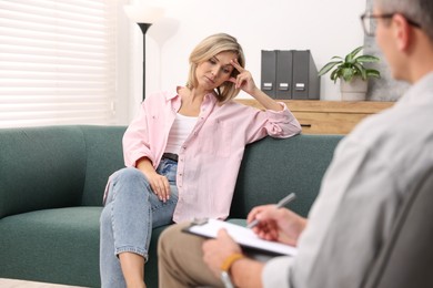 Photo of Professional psychologist working with patient in office, closeup