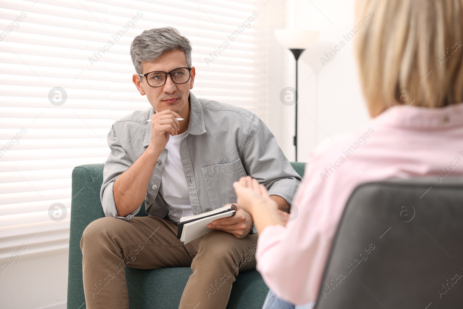 Photo of Professional psychologist working with patient in office