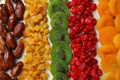 Photo of Different dried fruits on light table, flat lay