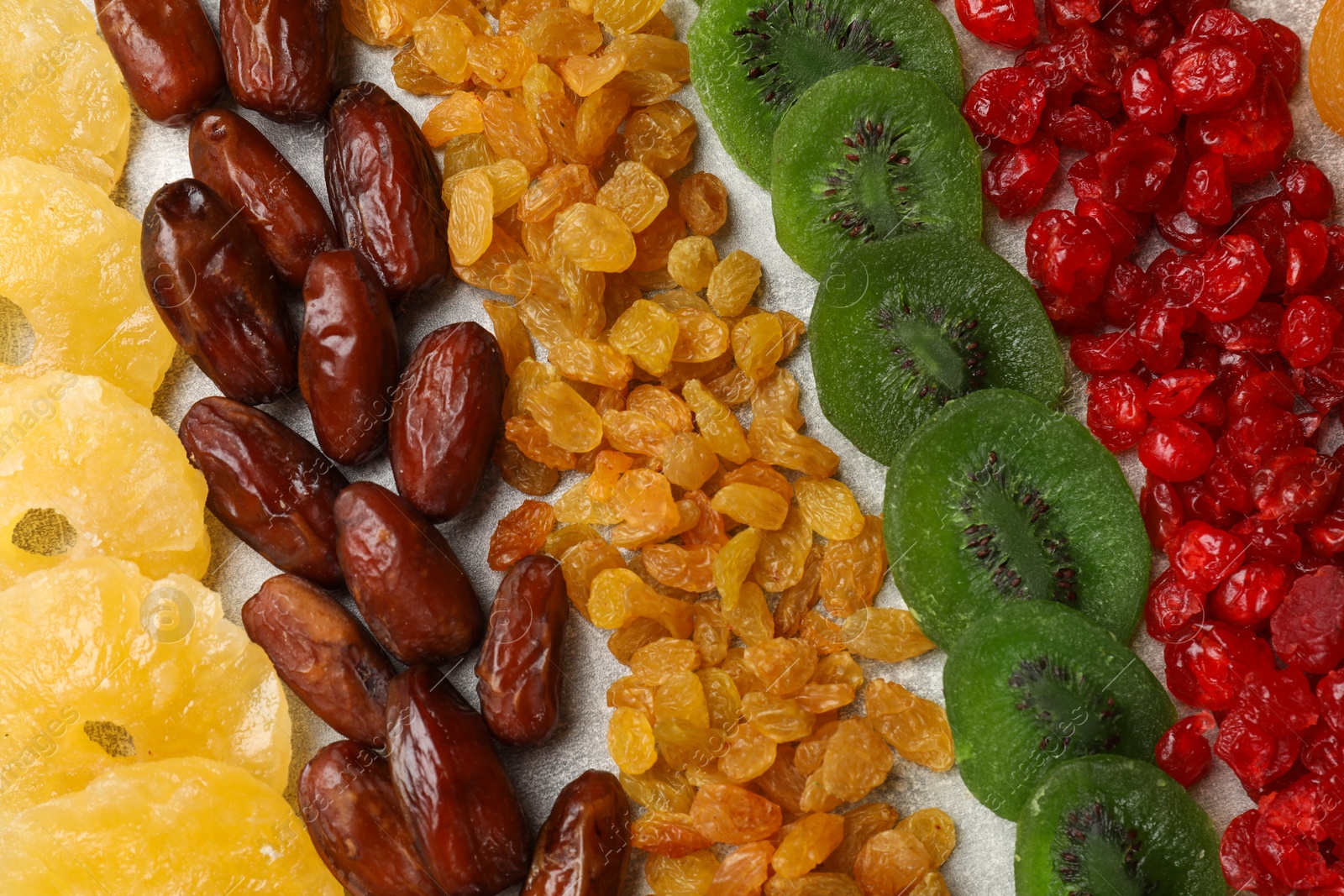 Photo of Different dried fruits on light table, flat lay