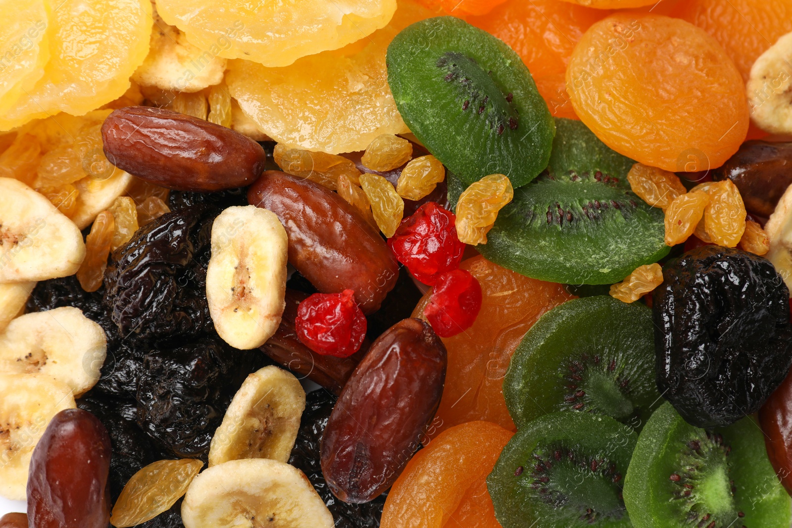 Photo of Mix of different dried fruits as background, closeup