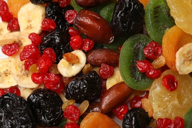 Photo of Mix of different dried fruits as background, top view