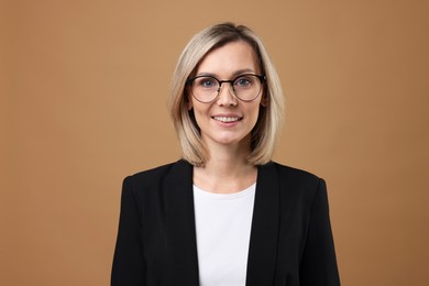 Photo of Portrait of businesswoman in glasses on beige background