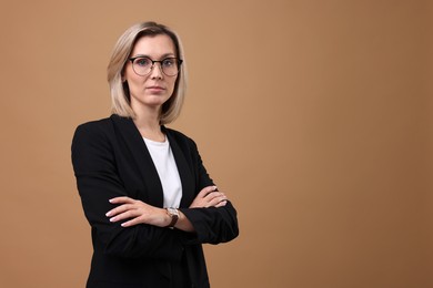 Photo of Portrait of businesswoman in glasses on beige background, space for text