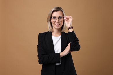 Photo of Portrait of businesswoman in glasses on beige background