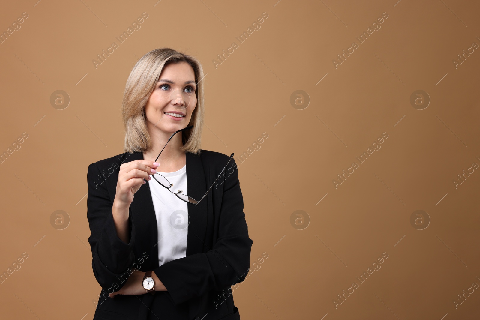 Photo of Portrait of businesswoman with glasses on beige background, space for text