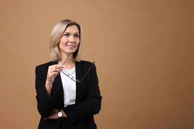 Photo of Portrait of businesswoman with glasses on beige background, space for text