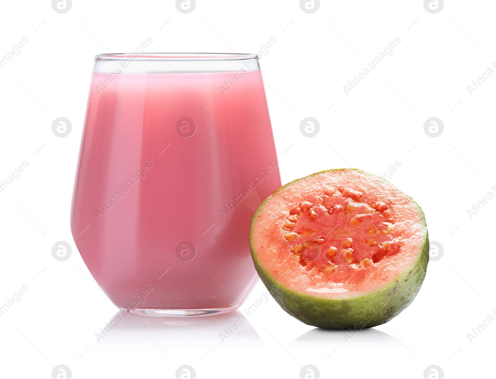 Photo of Tasty guava juice in glass and fresh fruit isolated on white