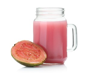 Photo of Tasty guava juice in mason jar and fresh fruit isolated on white